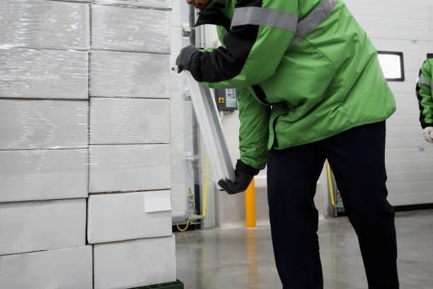 istock Plastic wrapper roll to packaging in loading goods of the freezing warehouse., Storage for Coronavirus Vaccine in cold room., Export-Import Logistics system concept. Focus shooting on package box. 1337381213