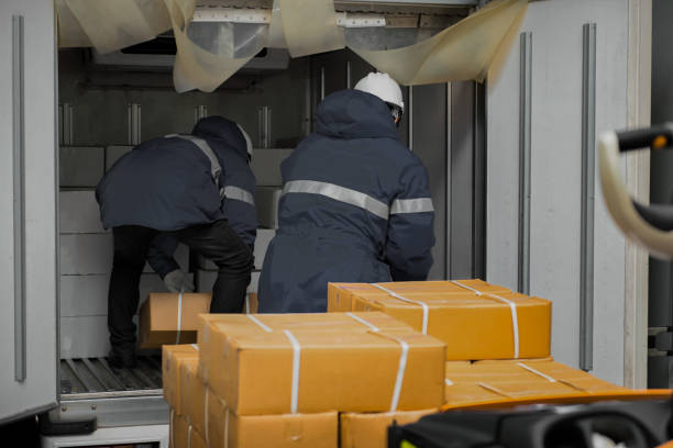 Manual worker working with package boxes for transport by pickup at gates for goods in loading area from warehouse to be processed export to customer stock photo