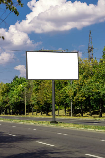 blank advertising billboard mockup. urban life. near park area. template for design. large advertising road banner stock photo