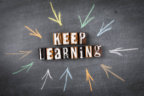 istock Keep Learning concept. Letters of the alphabet on a chalk board. Drawn arrows 1337381696