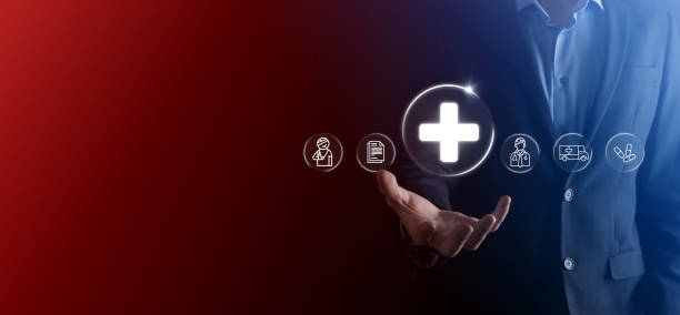 istock Businessman hold virtual plus medical network connection icons. Covid-19 pandemic develop people awareness and spread attention on their healthcare.Doctor,document,medicine,ambulance,patient icon. 1337382555