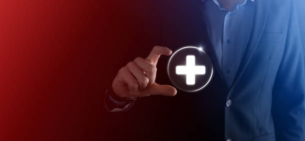 istock Businessman hold virtual plus medical network connection icons. Covid-19 pandemic develop people awareness and spread attention on their healthcare. 1337382559