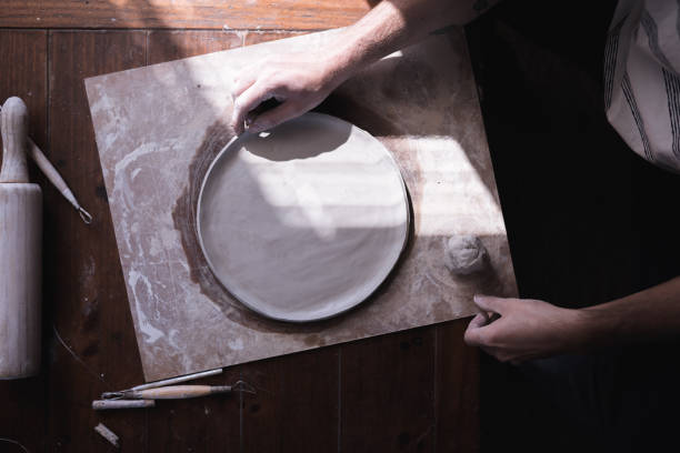 The process of making ceramic plate, man pinching clay