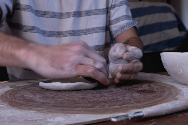 Hands moving as man works with clay