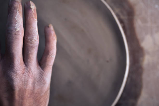 Close up of hand and half ceramic plate