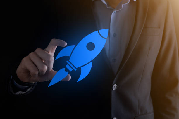 istock Start up concept with businessman holding abstract digital rocket icon rocket is launching and soar flying 1337385559
