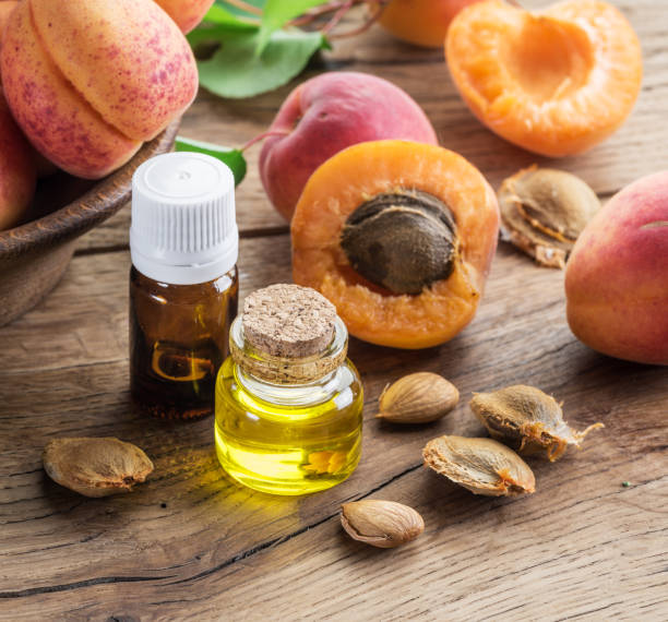 istock Apricot kernel oil and apricot kernels on wooden background. 1337386931