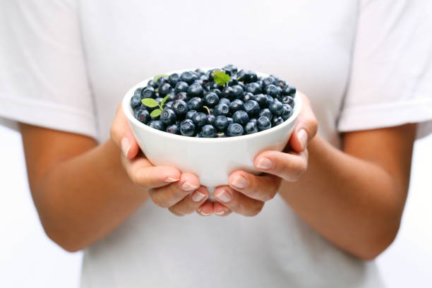 istock Crockery with blueberries in woman hands. 1337387056