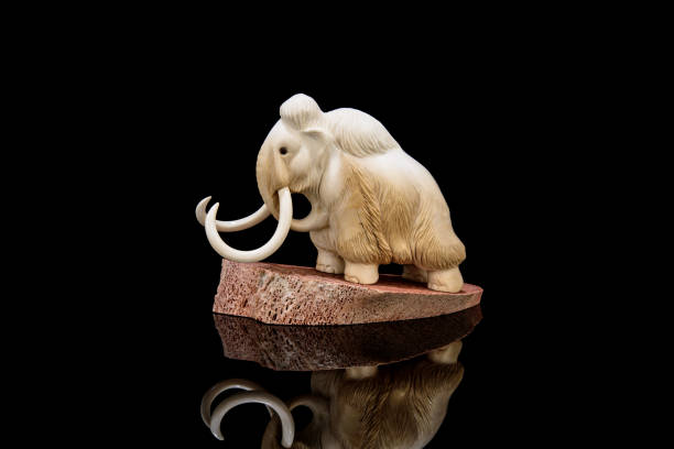 istock ivory statuette of elephant mammoth on black background 1337387099