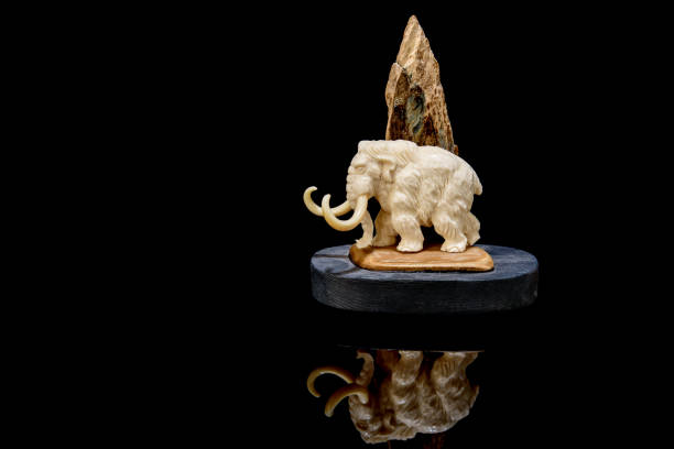 istock ivory statuette of elephant mammoth on black background 1337387110