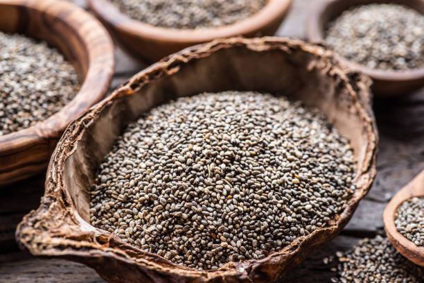 istock Chia seeds in organic dish on old wooden table. 1337387152