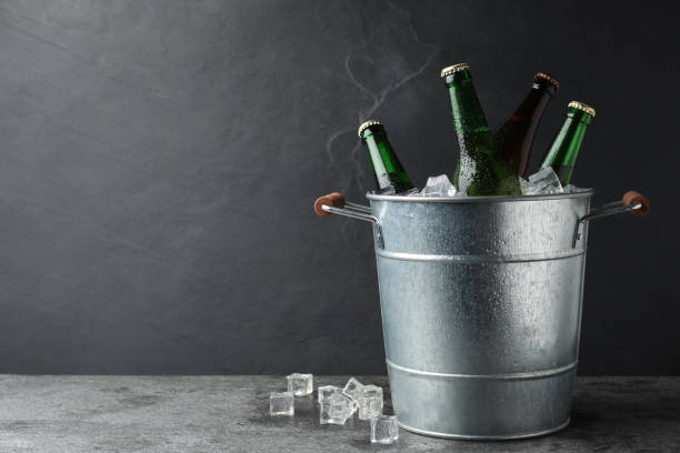 istock Metal bucket with beer and ice cubes on grey background. Space for text 1337387332