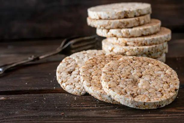 Healthy puffed rice cakes made with brown rice served isolated on rustic and wooden table background