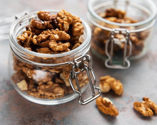 Walnuts  without shell Walnuts  without shell on a concrete background brain jar stock pictures, royalty-free photos & images
