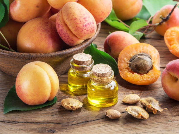 istock Apricot kernel oil and apricot kernels on wooden background. 1337391750