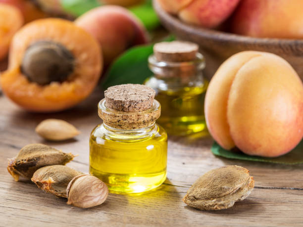 istock Apricot kernel oil and apricot kernels on wooden background. 1337391752