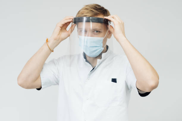 istock Man professional medic put on protective face mask. 1337391884