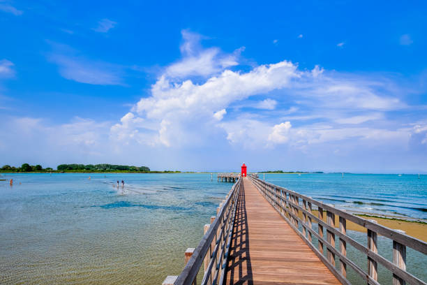 Red lighthouse at Punta Faro in Lignano Sabbiadoro, a summer tourist spot on the Adriatic see coast