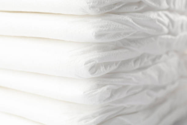 istock Stack of baby diapers as background, closeup 1337399800