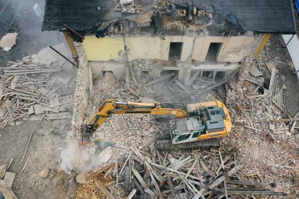 istock Yellow excavator destroys building 1337401596