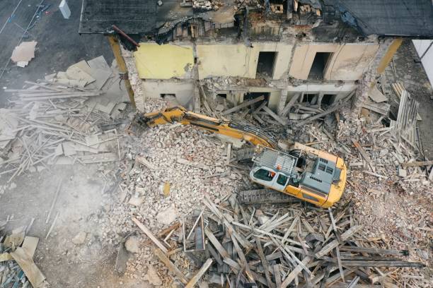 istock Yellow excavator destroys building 1337401604