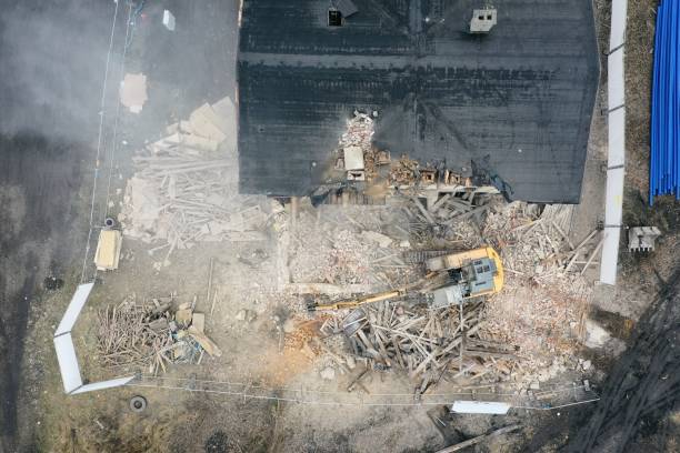 istock Yellow excavator destroys building 1337401609