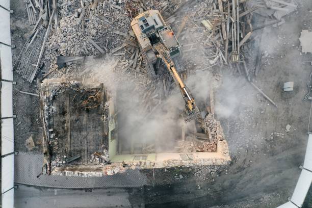 istock Yellow excavator destroys building 1337401723