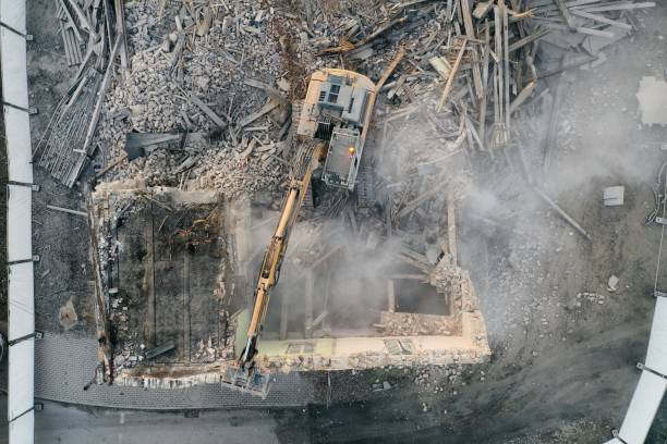 istock Yellow excavator destroys building 1337401738