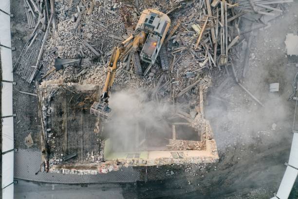 istock Yellow excavator destroys building 1337401743