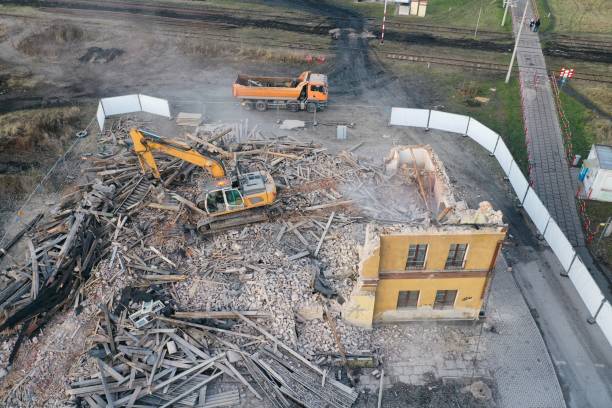 istock Yellow excavator destroys building 1337401797