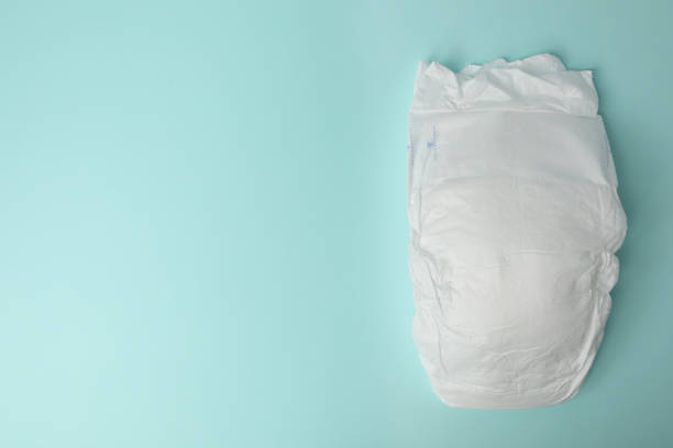 istock Baby diaper on light blue background, top view. Space for text 1337401814