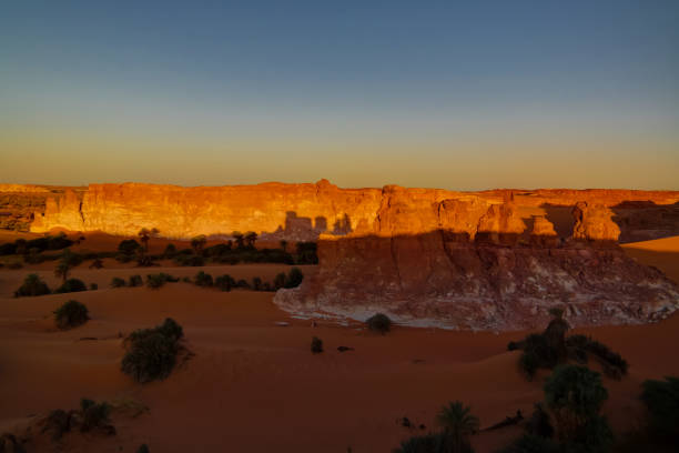 Sunrise at sandstone formation in the Sahara desert near Yoa Lake group of Ounianga Kebir, Ennedi, Chad Sunrise at sandstone formation in the Sahara desert near Yoa Lake group of Ounianga Kebir in Ennedi, Chad chad central africa stock pictures, royalty-free photos & images