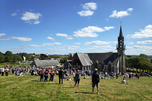 Plonévez-Porzay, France - August 29 2021: Tourists and pilgrims at the Pardon traditionally organized on the last Sunday in August at the Chapelle Sainte-Anne-la-Palud. A pardon is a typically Breton form of pilgrimage and one of the most traditional demonstrations of popular Catholicism in Brittany.