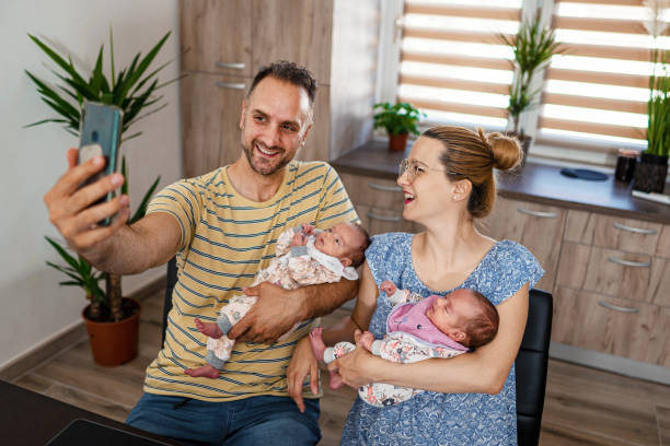 istock Parents with baby taking selfie at home 1337403553