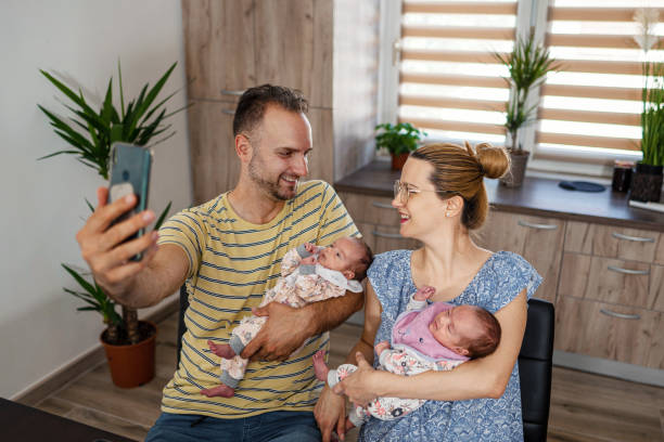 istock Parents with baby taking selfie at home 1337403732