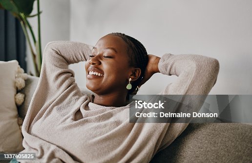istock Shot of a young woman relaxing on the sofa at home 1337405825