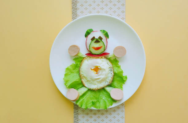 Eggs, vegetables in shape of bear. Food art. Funny dish.