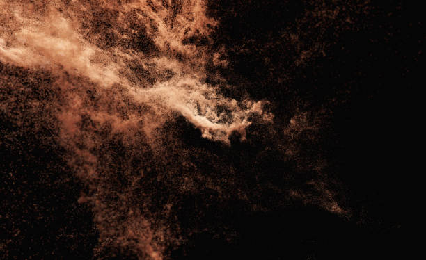 Explosion of yellow powder on black background