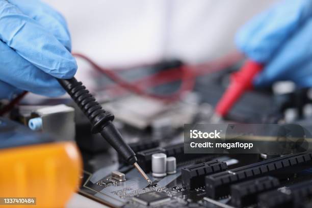 Master In Gloves With Equipment Is Testing Computer Motherboard Stock Photo - Download Image Now