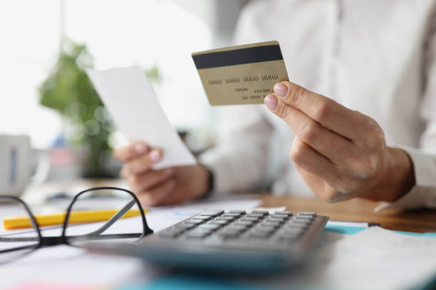 istock Credit plastic bank card and check in female hands 1337410491