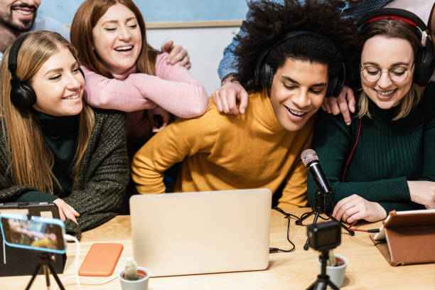 istock Happy diverse friends having fun streaming online using computer laptop and smartphone app - Main focus on african man face 1337410974