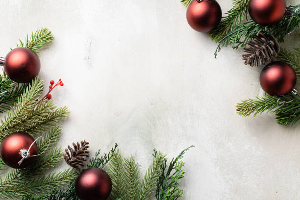 istock Christmas frame with fir tree branches on light wooden background 1337411881