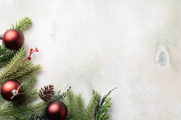 istock Christmas frame with fir tree branches on light wooden background 1337411897