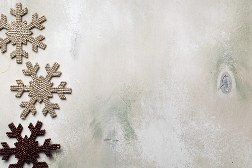 Christmas frame with snowflake on light wooden background