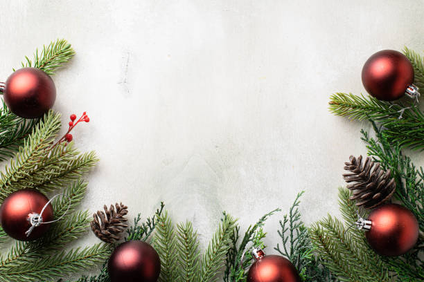 istock Christmas frame with fir tree branches on light wooden background 1337412014