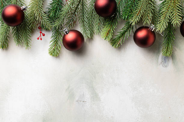 istock Christmas frame with fir tree branches on light wooden background 1337413922