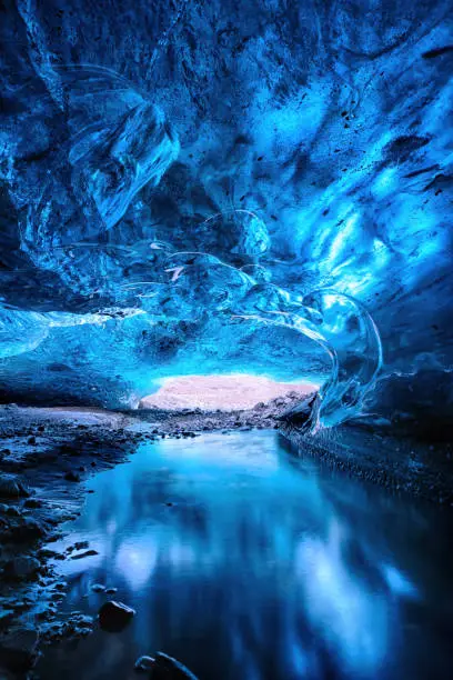 Glacial river flows through a blue ice cave. Part of the Vatnajokull glacier in southeast Iceland in winter.