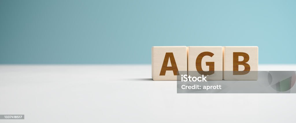"AGB" web banner - the German abbreviation for "Allgemeine Geschäftsbedingungen" (Terms and Conditions) built from letters on wooden cubes for the use as a web banner. Alphabet Stock Photo