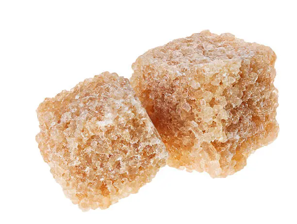 Two brown lump cane sugar cubes, isolated on white 