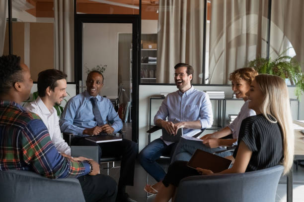 istock Smiling diverse employees laugh at team office meeting 1337424352